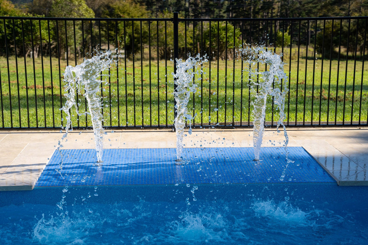 Blue Ezarri mosaic sundeck with deck jets on a fibreglass pool