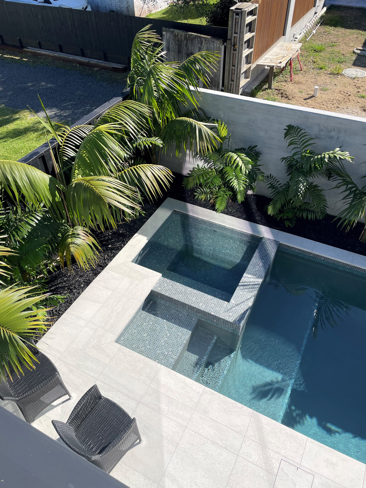 Spa with pale stone surround in a tropical garden