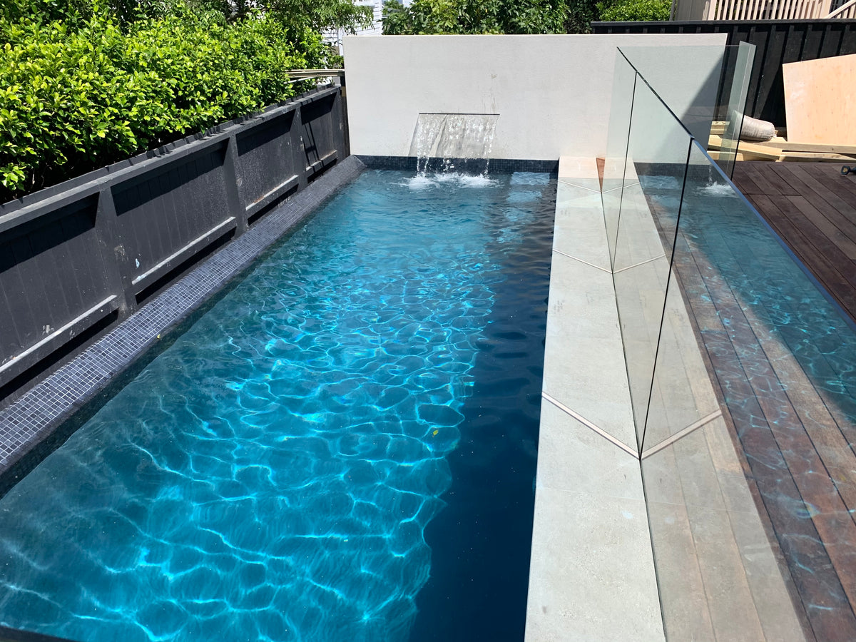 Mediterranean-Blue-Hydrazzo-with-sheer-decent-waterfall-and-porcelain-copings-copy.jpg__PID:ef689f03-4dcd-4621-86bf-9543991ad675