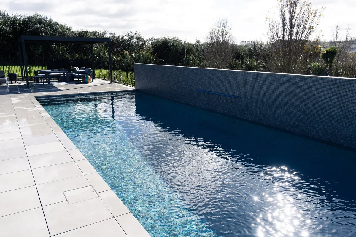 Porcelain rebated pool coping around a backyard pool