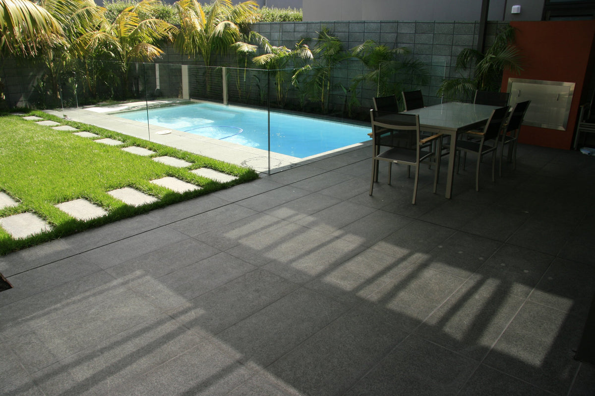 Black granite tiles on a pool terrace