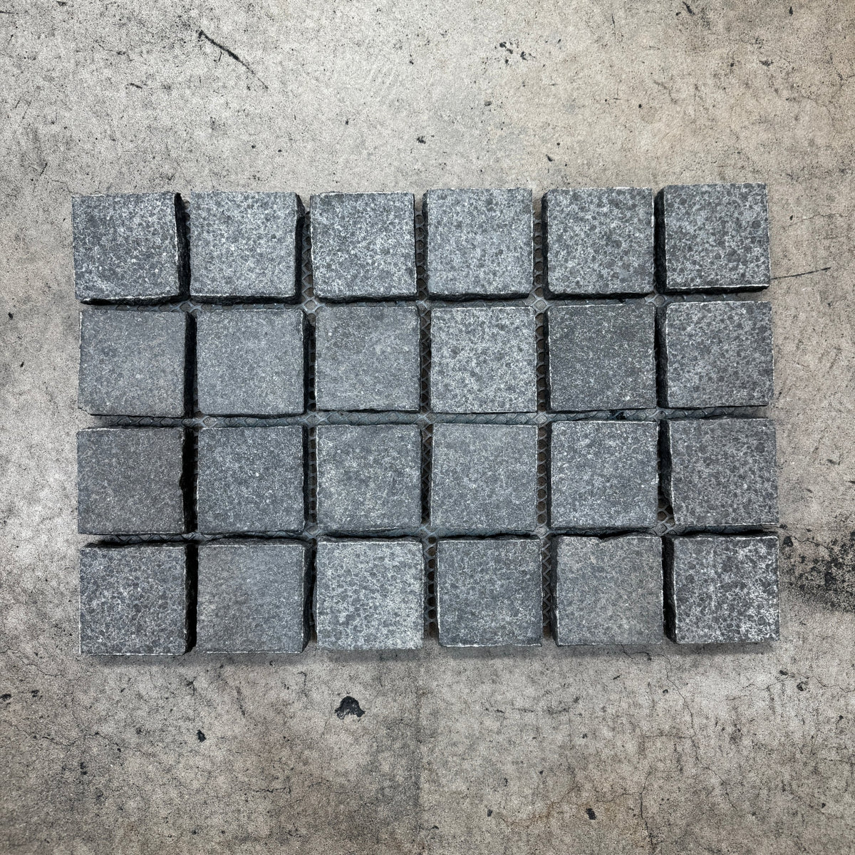 Black flamed granite cobbles on mesh, side by side pattern