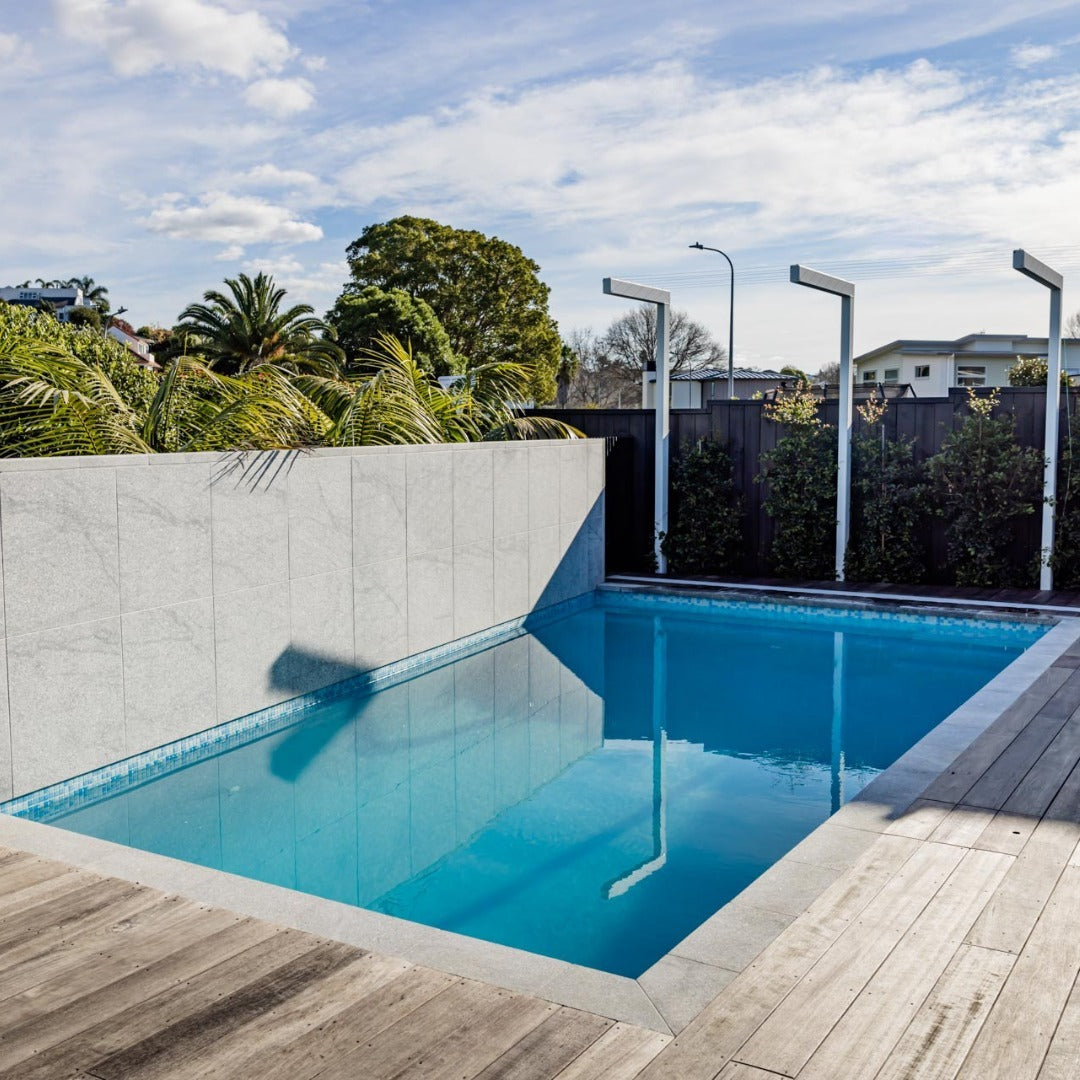 Fantasy granite square edge coping on a pool with timber deck