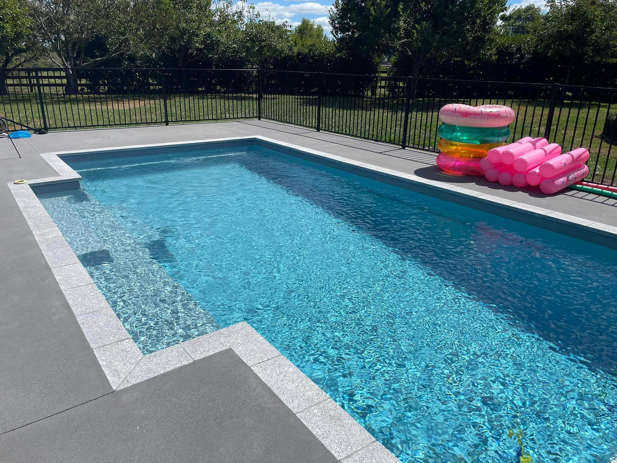 Fantasy granite square edge coping on a family pool