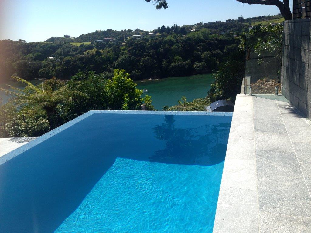 Fantasy granite bullnose coping on an infinity pool overlooking the water