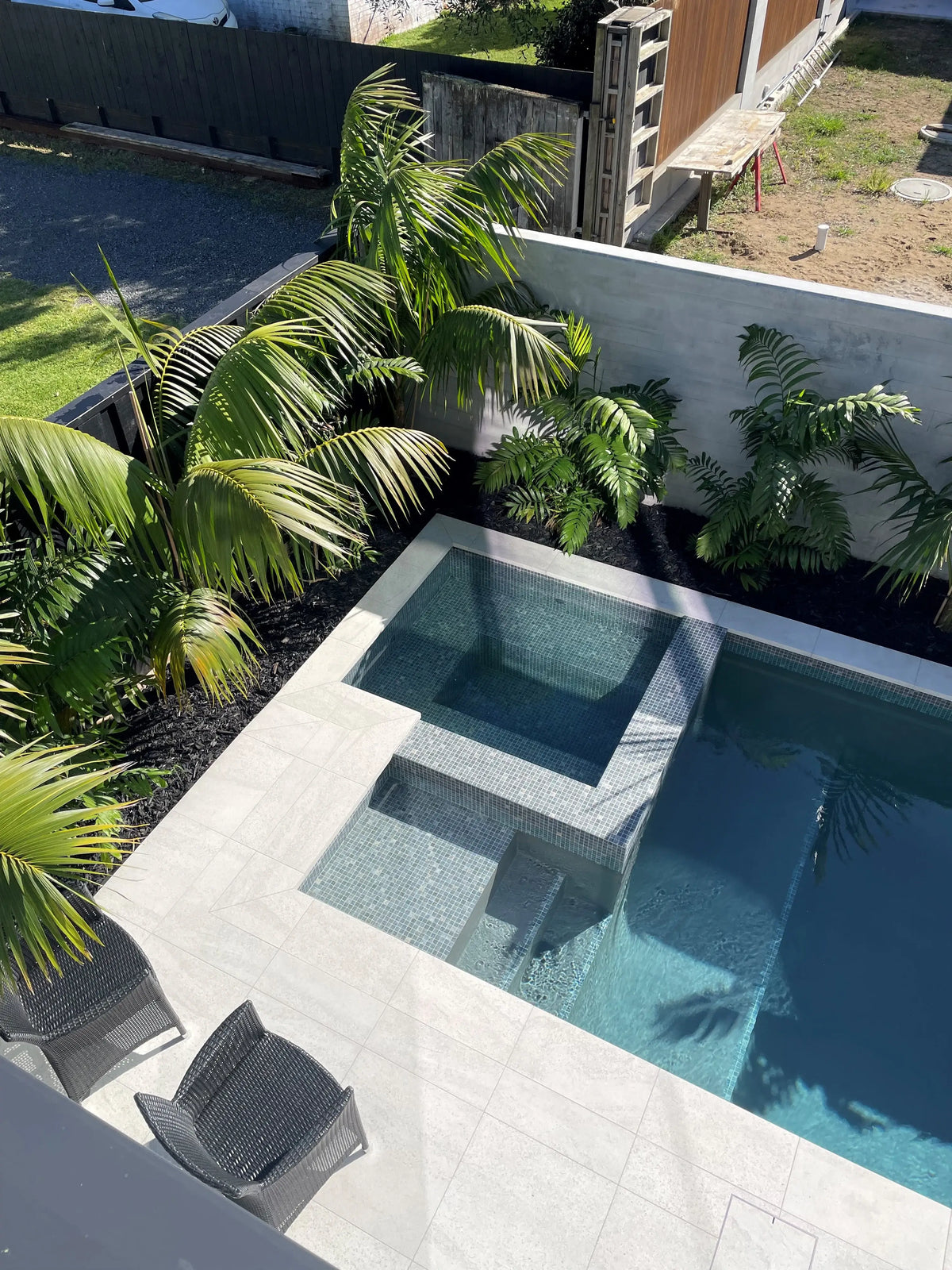 Spa with pale stone surround in a tropical garden