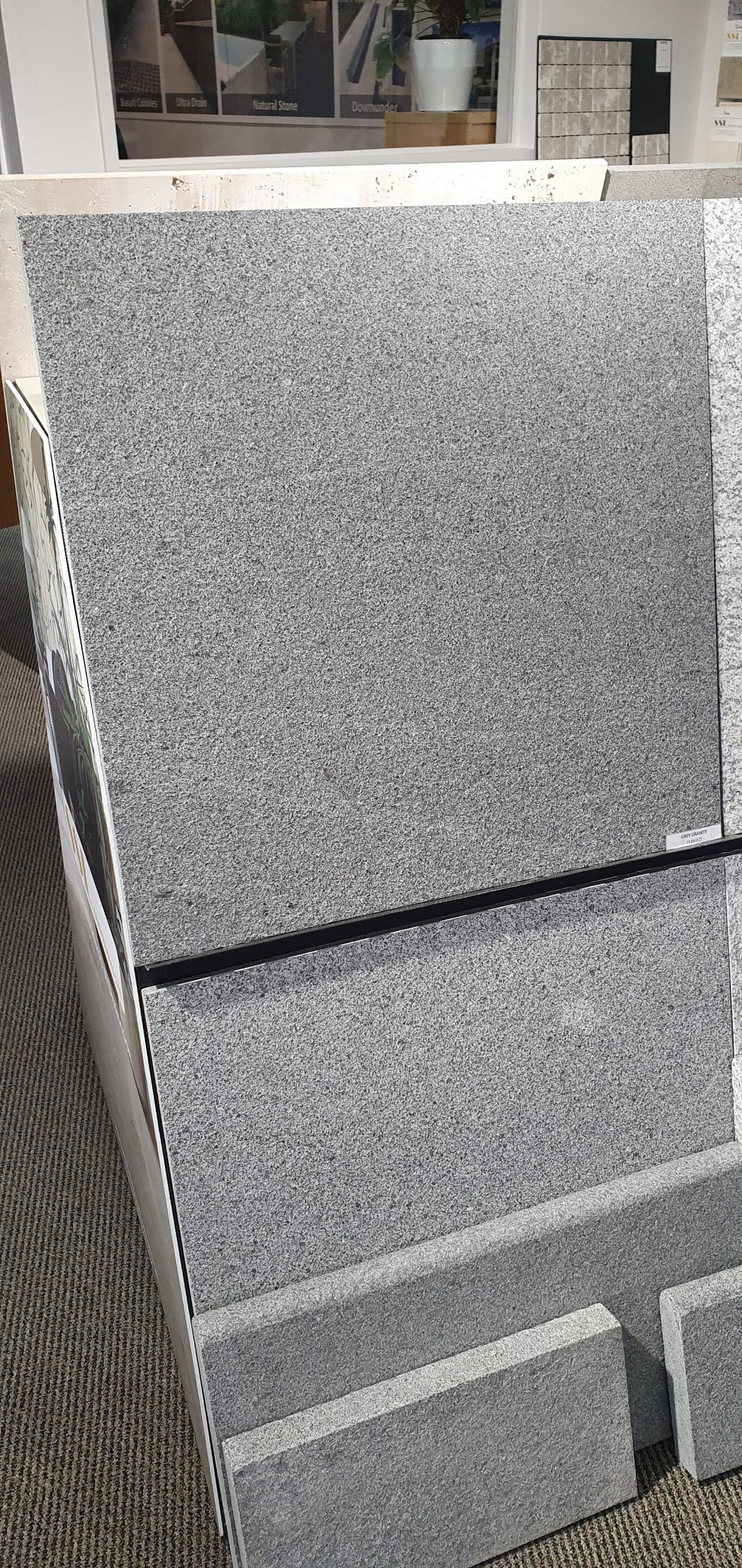 Flamed grey granite tile and coping samples on display in the SSL showroom