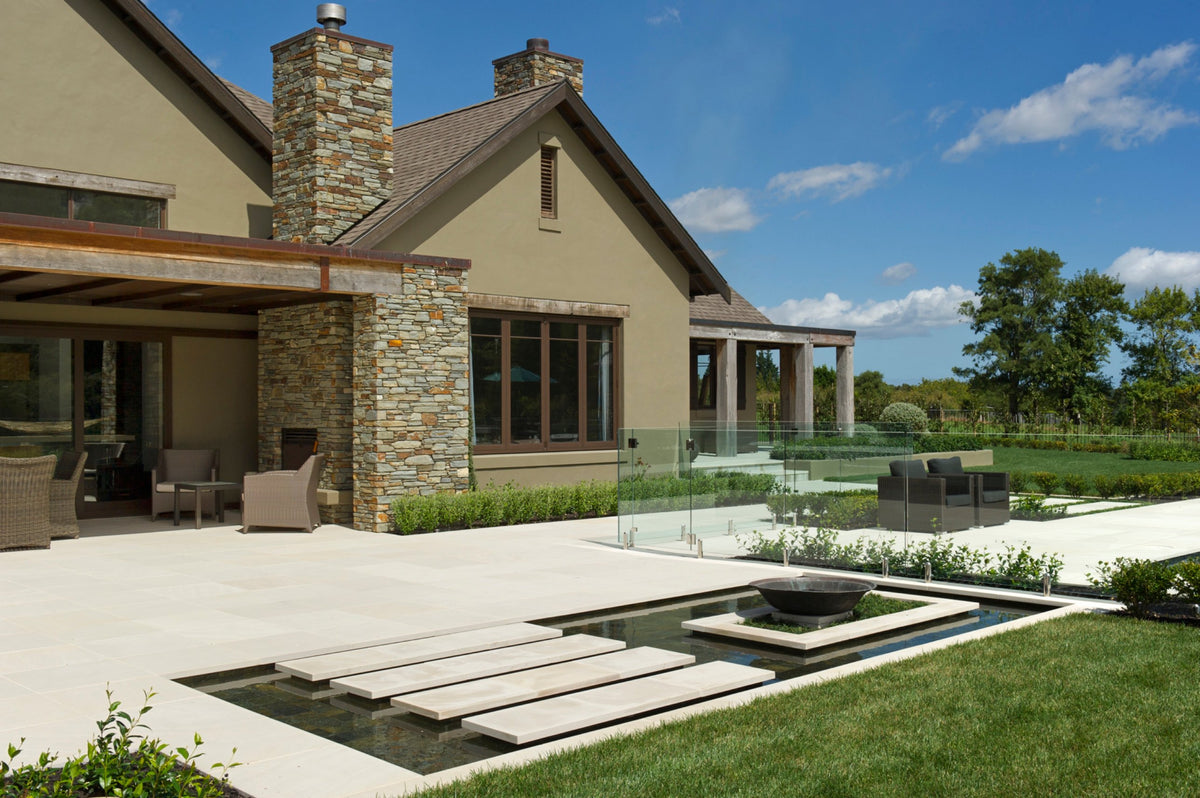 Sandstone terrace and floating stepping stones over a water feature