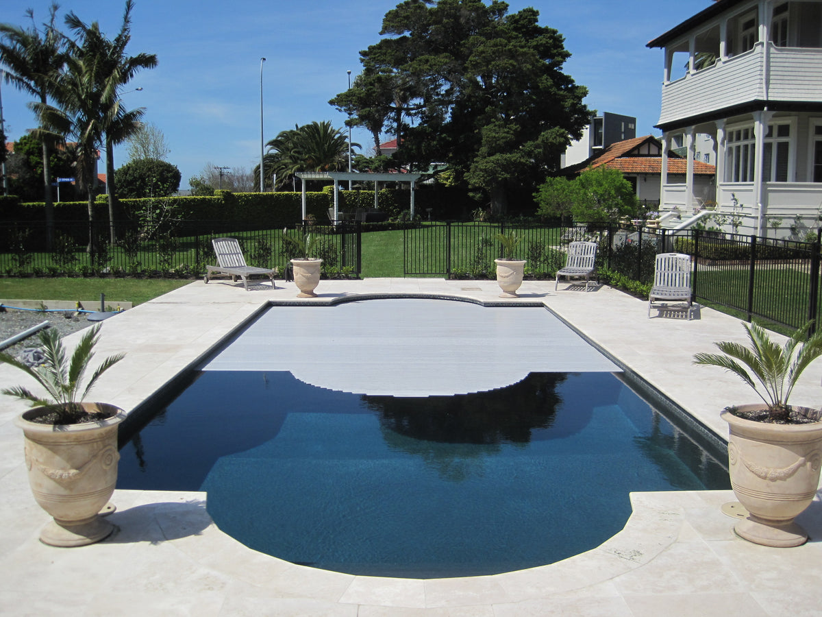 Travertine pool surround and paving on a classic pool